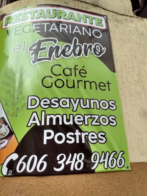 Sign posted outside at street level at El Enebro in Pereira
