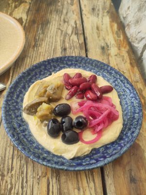 Hummus with black olives, red beans, caramelised onions and pickled eggplants. at Salt & Pepper in Medulin