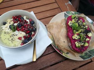 avodaco banana smoothie bowl and beetroot avocado hummus bread  at Artelier Cafe & Bar in Bratislava