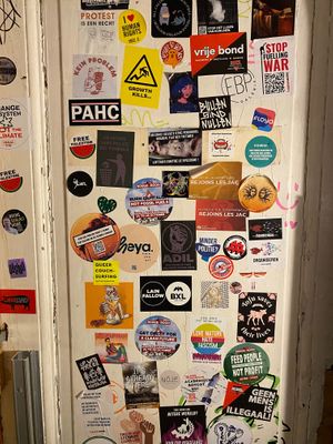 Political and funny stickers in the bathroom  at Kitsune Burgers in Brussels