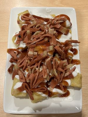 Potatoes with shredded bacon - a must try!  at A Flama in Zaragoza
