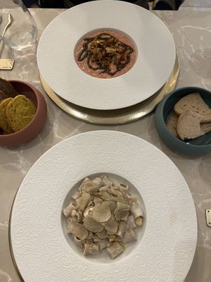 Rissoto (very complex flavors), Cashew & Truffle (creamy), provided bread on left and provides gluten free bread on the right (served warm)    at Linfa in Milan