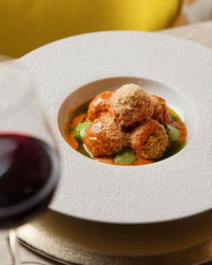 Pea-balls with San Marzano tomato cream, herb mix and basil-flavored olive oil at Linfa in Milan