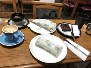Our full order. Flat white with oat milk, breakfast tea with oat milk, two vegan wraps and an Oreo brownie   at Wyndenwell in Bamburgh