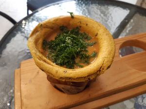 Vegan lentil soup in turmeric cup. at Soup Culture in Bratislava