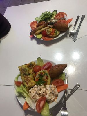 The bottom plate is completely vegan. The top one has the rolls that have cheese and the fish, which makes it non vegan.   at Paşa Hamam Cafe in Istanbul