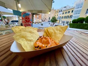 Tapita y la vista de la plaza. Karma Cola fair trade at Cala Vegana in Menorca