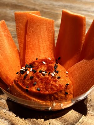 House offering: mise en bouche Carrots with orange hummus(?)  at Cala Vegana in Menorca