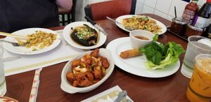 Spread of egg rolls, fried rice, garlic chick'n, fish, Thai tea at Thuyen Vien in Anaheim
