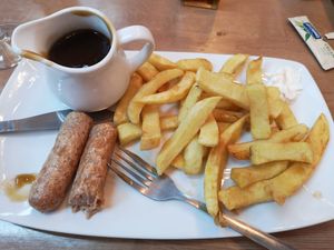 Vegan sausages and chips with gravy. at Barnacles in Llandudno
