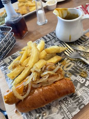 Hot dog with fried onions, curry sauce, chips and vegan garlic mayo (all half eaten - whoops!)  at Barnacles in Llandudno
