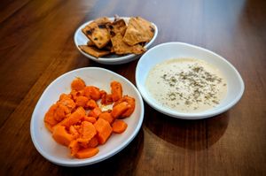 Nibbles while you wait, carrots with cumin, deliciously charred pita chips, and tahini at TLV in Marietta