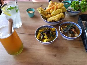 Clock-wise: deep-fried vegetables, spring rolls, tofu and eggplant, tofu and plantan, bubble tea, lemonade at La Vegana in Warsaw