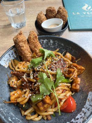 Udan Wheat noodles, Crispy Cutlet and sauce.. Background are crispy seitan chunks which were 80% batter and half under cooked  at La Vegana in Warsaw