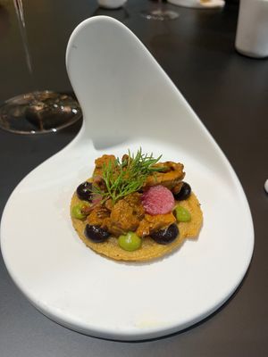 Masa churro, chanterelle, black garlic, pipian rojo, and mezcal.  at MITA in Washington