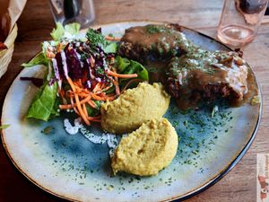 Nut roast: roti made with chestnuts, oats, nuts and vegetables, served with a seasonal vegetable purée and Gravy miso and onion sauce, with a small salad. at Moon and Sons in Caen