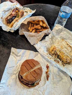 Chicken sandwich, Italian sausage sandwich, street corn, and friend fries at Plant Based Heat in Memphis