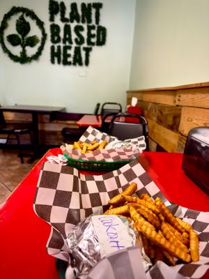 Cool green sign on the back wall! at Plant Based Heat in Memphis