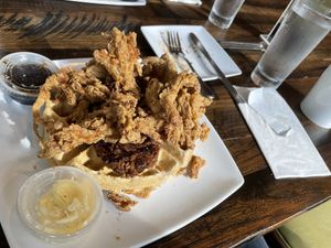 Chicken fried shooms waffle with a cheeky side sausage thrown in 😃  at Mo' Brunch + Brews in Houston