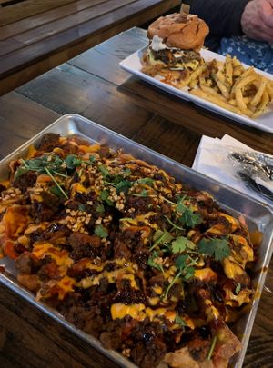 Viet-nachos (front) and blue cheese burger (back) as part of Houston Sauce Company night menu  at Mo' Brunch + Brews in Houston