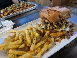 Black & Bluesy Burger with Viet-Nacho in the background   at Mo' Brunch + Brews in Houston