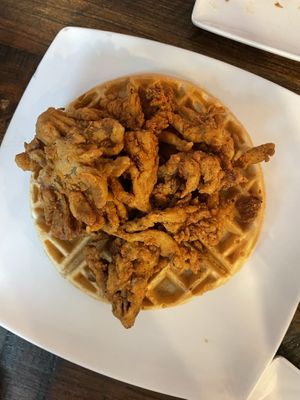 Waffles topped with Chikn Fried Shrooms tossed in our Hot Honey (Spiced Agave) syrup.  at Mo' Brunch + Brews in Houston