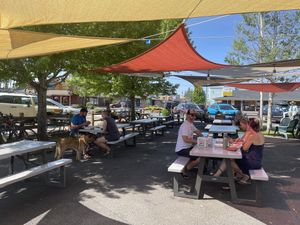 adjacent shaded seating area outside of Eurosports shop which has a rotating tap for beer and cider at Coco Loco Taco Bar in Sisters
