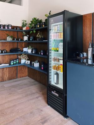 Interior merchandise shelves, takeaway fridge, condiment counter. at Elegy Coffee in Nashville