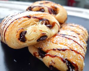 Chocolatine 
A French Classic. Fresh baked layers of golden brown light pastry with Chocolate in the middle at Chikun Shak in Mount Brydges