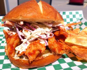 Chipotle IPA BBQ Chikun
Big tender pieces of Chunky Chikun coated in our house made Chipotle IPA BBQ sauce topped with a Ranch Slaw and pickled Jalapenos on a Pretzel bun. at Chikun Shak in Mount Brydges