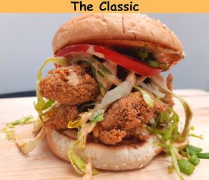 The Classic
Golden brown and delicious Crispy Fried Chikun Bites with our House CS Sauce, Lettuce, Tomato, Pickles and Green Onions on a soft toasted Brioche bun. at Chikun Shak in Mount Brydges