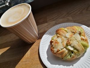 Pistachio bun and Caffè latte with oat milk at Gateau - Kaivokatu in Helsinki