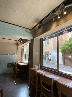 Super cute fixtures (zoom in on that little table and chairs hanging from the ceiling!)  I loved the open windows.   at Mothers Table in Seoul