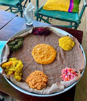 Ethiopian platter and wraps 
  
Gluten free Injera with hearty traditional Ethiopian stews and vegs is one of our main meals. at Tribearth  in Diani Beach