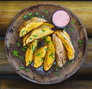 Herbed potato wedges with vegan aioli sauce at Tribearth  in Diani Beach
