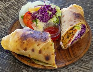 Vegan Beef Shawarma chapati wrap with caramelized onions, salad & vegan garlic mayonnaise at Tribearth  in Diani Beach