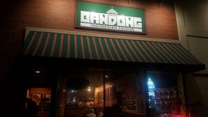 Outside of store in a strip mall with small parking lot at Bandung Indonesian Restaurant in Madison