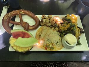 Vegan cheese with Tortillas, Pico de Gallo, fried potatoes and fresh & local veggies and a freshly baked pretzel at Bagel St-Henri in Montreal