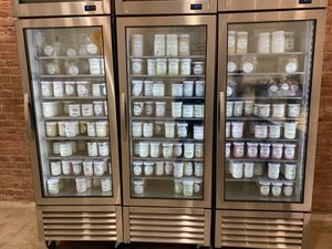 Freezer filled with pints in glass jars at Ginger's Divine Ice Creams in Los Angeles