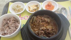 Bulgoggi  vegan jiggae (stew) with mixed rice and several side dishes, half eaten.  
 at Loving Hut Gangnam-gu - 러빙헛 in Seoul