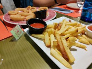 Patatas bravas with very spicy sauce! And onion rings at Piccolo in Cuenca