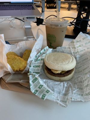 Muffin breakfast sandwich with hash browns and iced coffee  at Vegan Shack - Piccadilly Gardens in Manchester