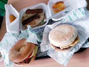 Breakfast menu. Bacon bagel, shack muffin, pancakes with syrup (and extra bacon), and hashbrowns at Vegan Shack - Piccadilly Gardens in Manchester