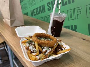 BBQ Loaded fries with added onion ring, Oreo milkshake  at Vegan Shack - Piccadilly Gardens in Manchester