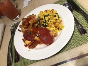 Vegan tofu scramble, polenta and breakfast potatoes with fresh juice  at Wynn Hotel - The Buffet in Las Vegas