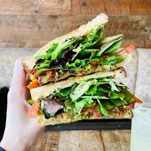 Vegan Caprese Panini: Peppers, sun dried tomatoes, Roma tomatoes, basil, organic mixed greens, hummus, pesto, and olive spread  at Freesoulcaffe in Tustin