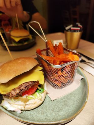 Vegan burger (soy, green peas burger), with vegan cheese, lettuce, tomato and avocado, served with sweet potato fries at La Rambla in Lloret De Mar