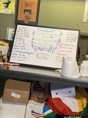 Daily menu written on a dry board  at Vegetarian Delight in Miramar