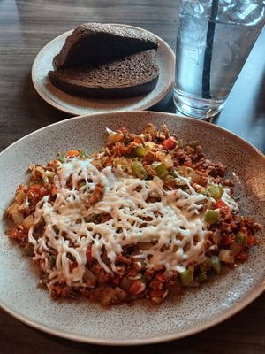 Vegan Hash: vegan chorizo w/ red & green peppers, onion, & vegan mozzarella. Choice of dry toast: Dark rye at Early Bird Brunch in Papillion