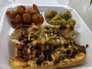 Philly cheese steak trio, cheese steak smothered in house made cheese sauce, with fried okra & spicy cauliflower nuggets. at Kales Kitchen  in Houston